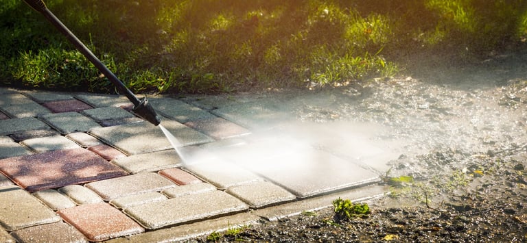 Driveway pressure washing removing oil stains and dirt buildup