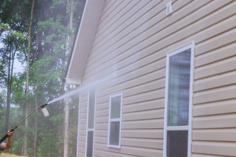 House siding being pressure washed